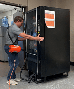 Man moving a vending machine